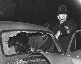 a policeman with a car damaged in a road accident