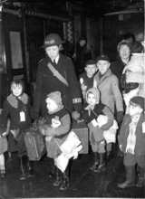 Woman police officer accompanying evacuee children in London