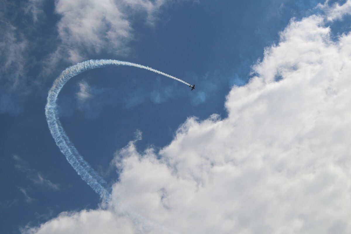 Plane looping over a cloud
