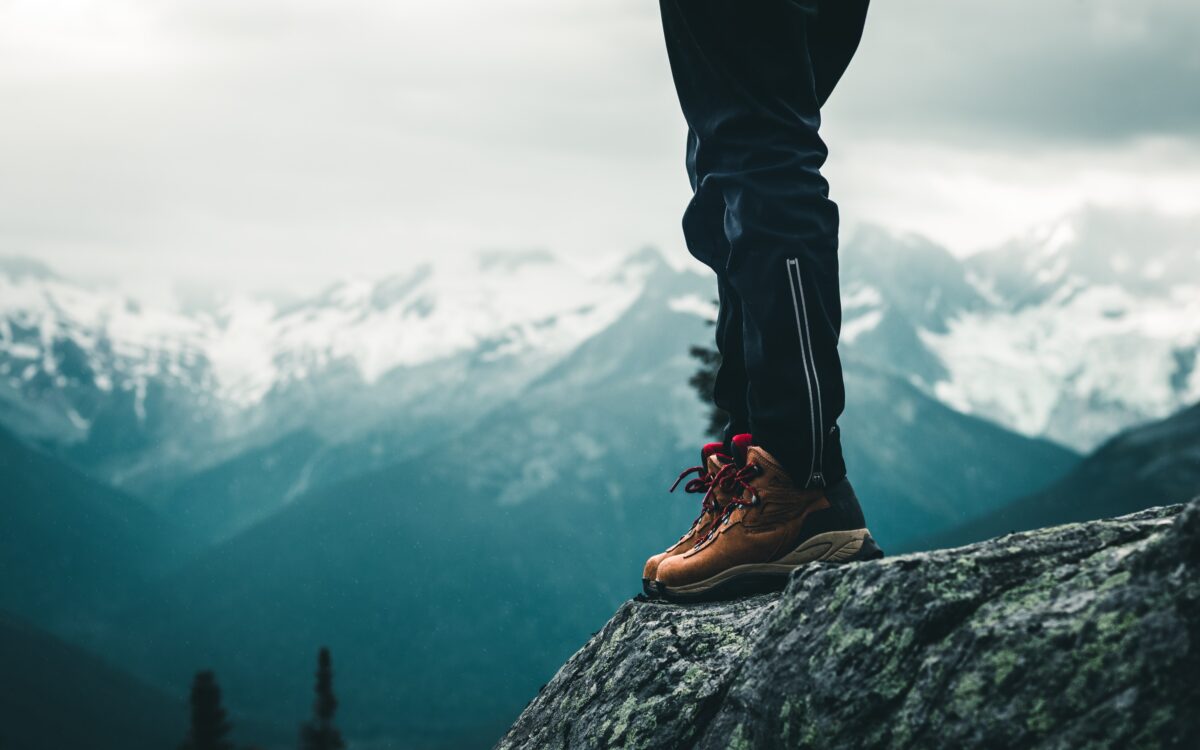 Hiker in boots at the top of a mountain