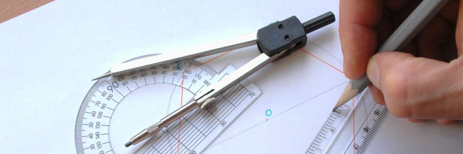 Close up of a hand using a ruler and compass to draw a mathematical diagram