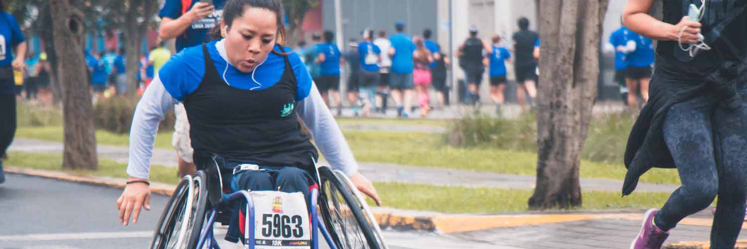 Female athlete using racing wheelchair