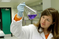 female scientist looking at liquid