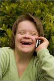 An image of Ruth, with her phone to her ear, laughing as she looks at the camera