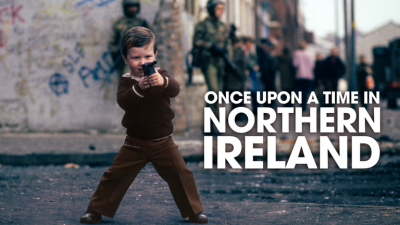 A young boy holding a gun on the street next to an overlaid text graphic that reads: Once Upon a Time in Northern Ireland