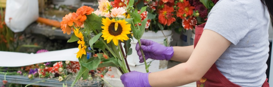 a lady sorting through some flowers