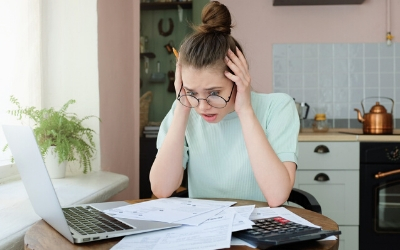 Worried woman looking at financial paperwork