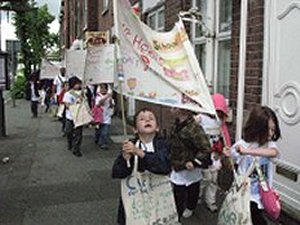 Children walking holding banners