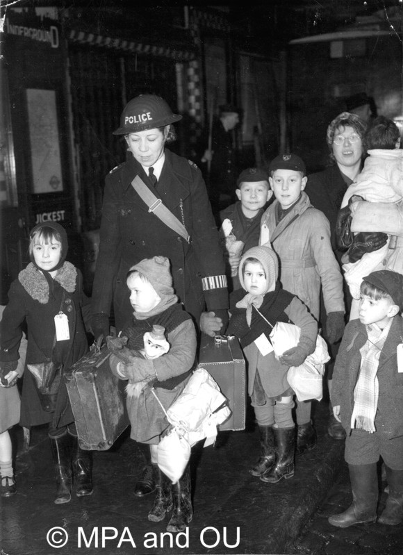 Woman police officer accompanying evacuee children in London
