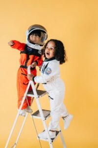 Two children in astronaut costumes