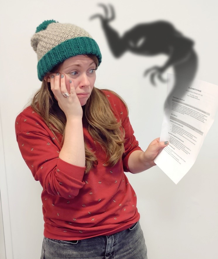 OU Career Consultant Penny Beecroft holding a CV with a ghost emerging from it.