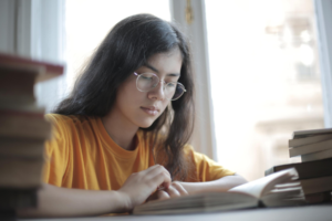 A female student reads a book.
