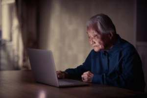 Elderly Asian lady using a laptop