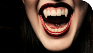 Photo of woman's mouth wearing lipstick showing vampire teeth