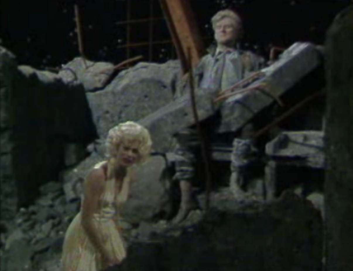 Io is shown visiting Prometheus and telling the story of her torment by Zeus who sent gadflies to pursue her round the world. Played by Julia Hills, Io was costumed as a Marilyn Monroe look-alike. Ancillary material to the course included a video clip of Marilyn Monroe singing ‘Happy Birthday Mr President’ at a birthday party held for President John F Kennedy.