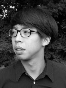 Black and white headshot of middle-aged Asian male author Rattawut Lapcharoensap. Author has short hair and is wearing circular glasses and a collared shirt.