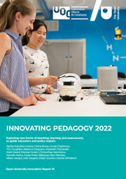 The cover of the 2022 Innovating Pedagogy report, showing two females interacting with some electronic equipment in front of a laptop.
