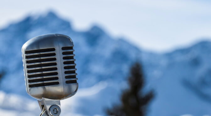 Image of a microphone set against mountains