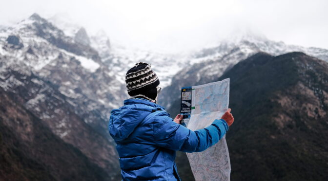 Image of mountaineer reading a map