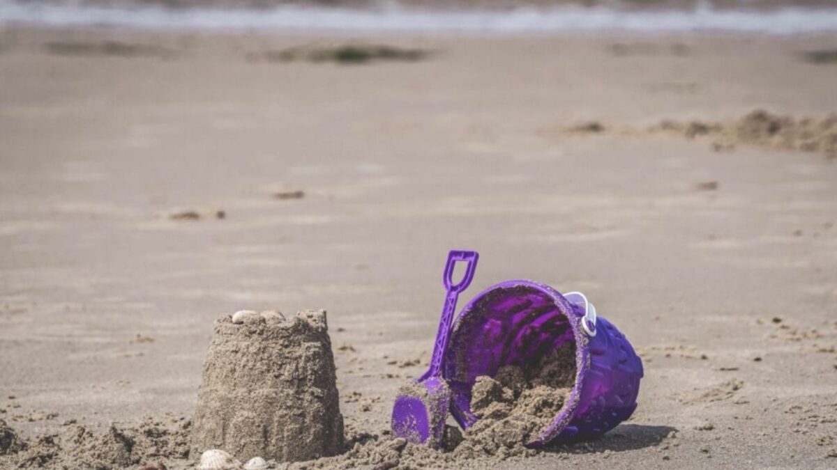 Bucket and sandcastle on a beach