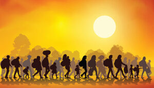 Refugees walking along with their belongings. Image credit:Thinkstock
