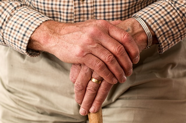 Male pensioner holding his hands together