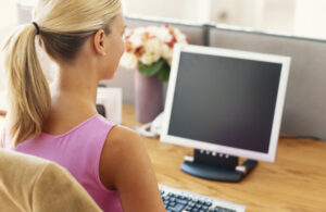 Woman sitting at a desktop computer