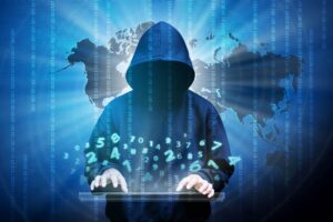 Computer hacker silhouette of hooded man with binary data and network security terms. Thinkstock