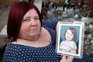 Michelle Johnson-Hadaway holds a photo of her daughter Karen