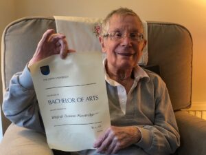 Wilfred Mansbridge holding his OU degree certificate