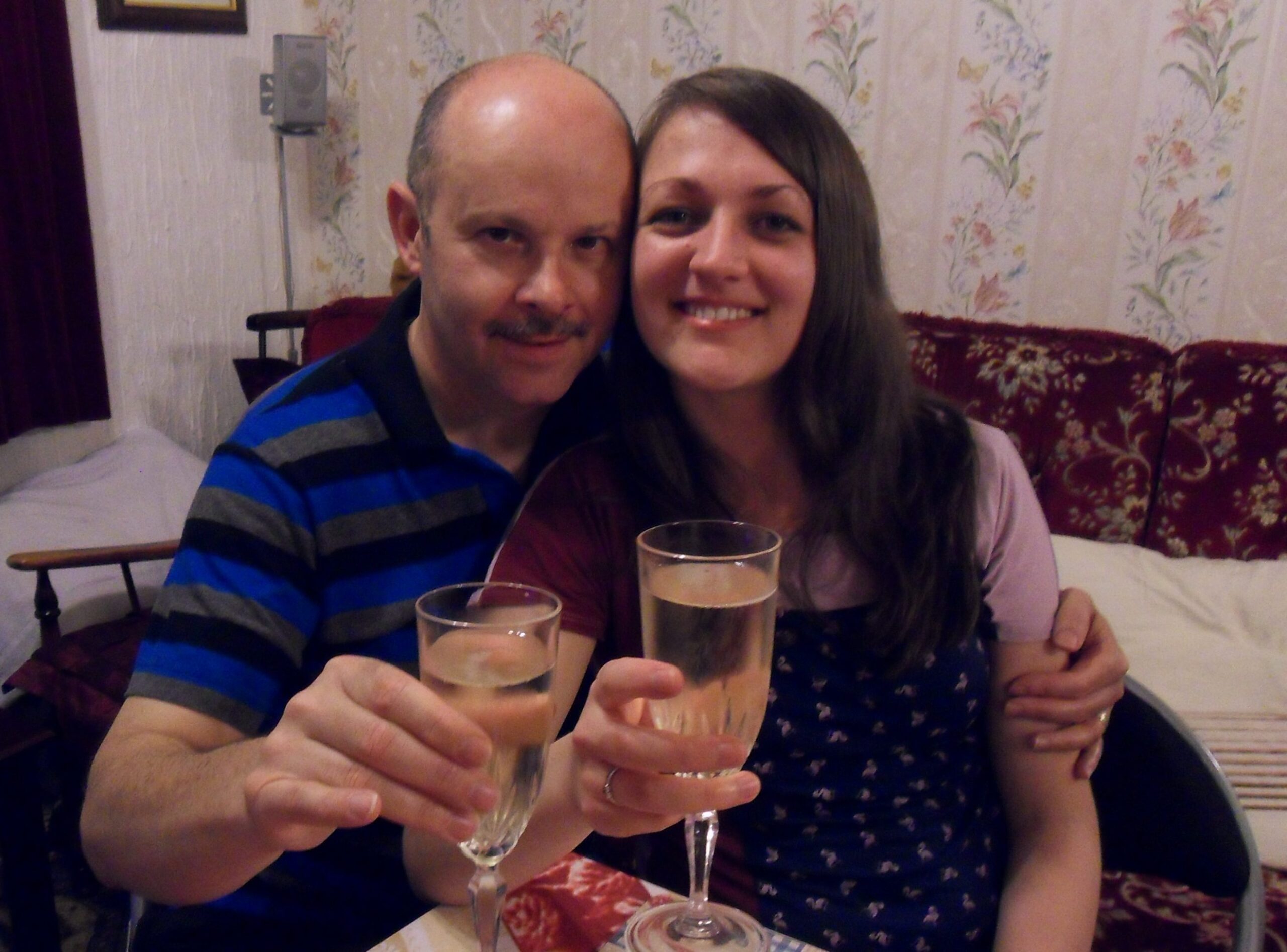 Donna and her husband toasting with a glass of champagne