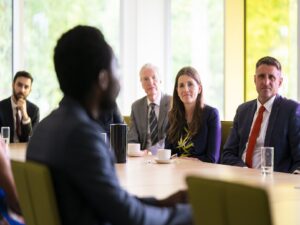 Michelle Donelan, Universities Minister and Ben Everitt, MP for Milton Keynes North talk to students from The Open University with Professor Tim Blackman, Vice-Chancellor.