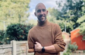 Photo of Dan Richards standing outside, smiling