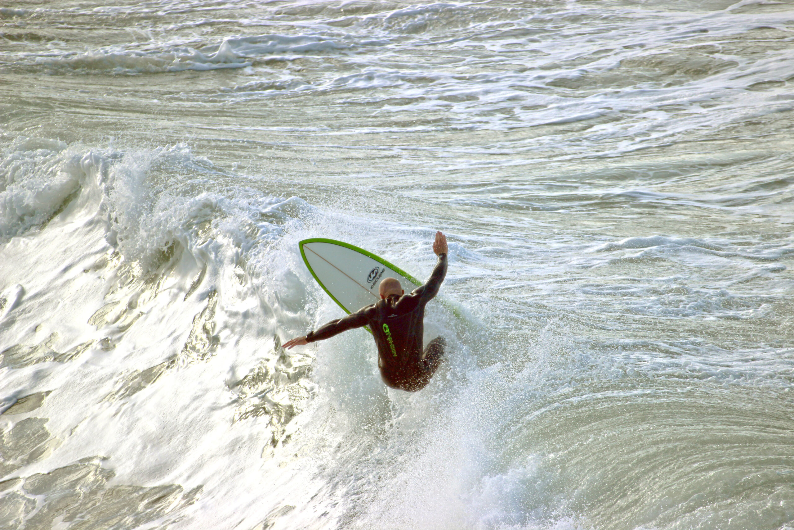 Image of a surfer catching a wave.