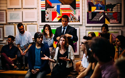 Photo of a seminar with a group of individuals engaged in a conversation