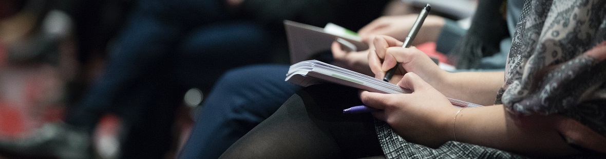 People taking notes at conference CREDIT Climate Reality on Unsplash