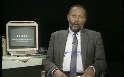 Image shows Stuart Hall in a TV lecture