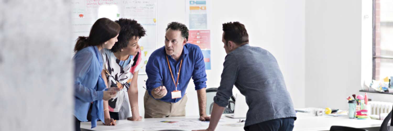 Four professionals having a stand up meeting