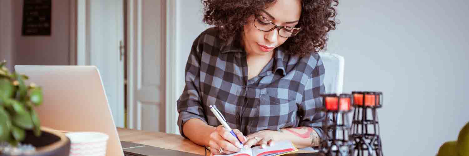 Young woman using a typewriter at home