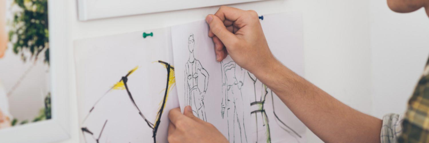 creative design university courses Design student pinning up fashion sketches