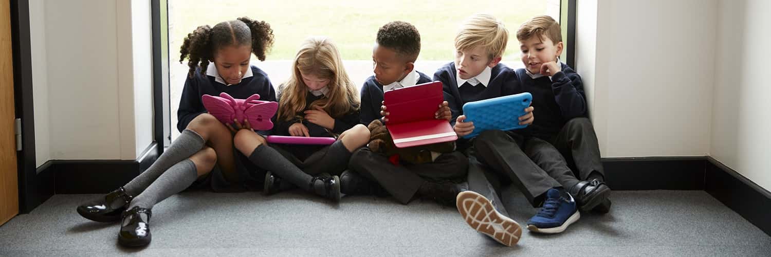 Group of young children with electronic devices