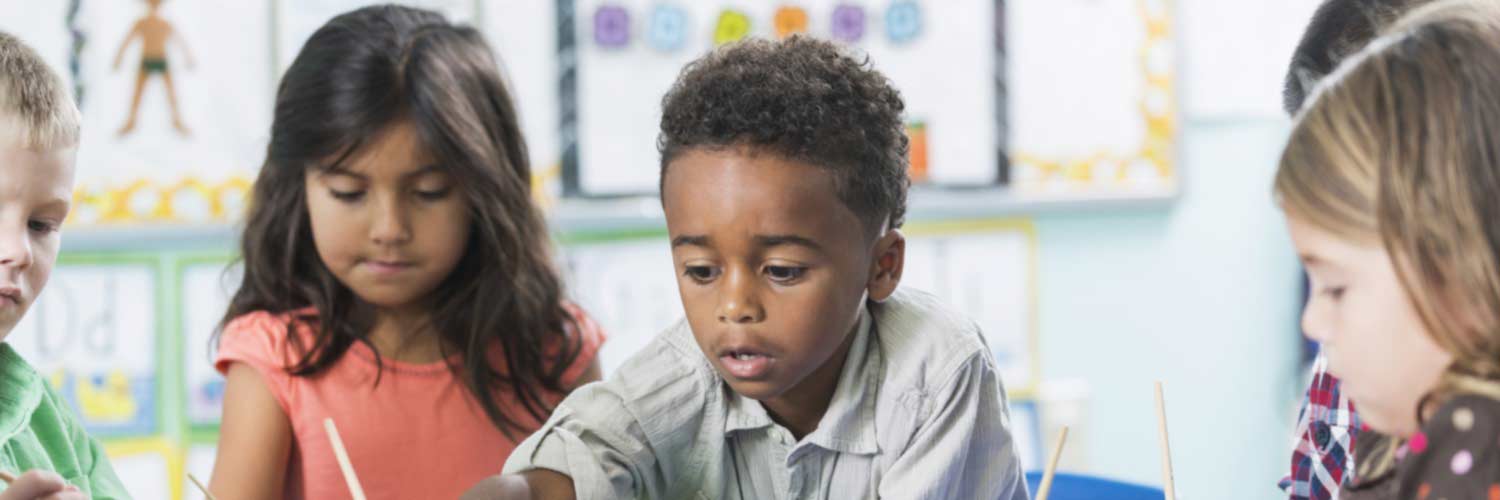 Group of young children taking part in a classroom activity