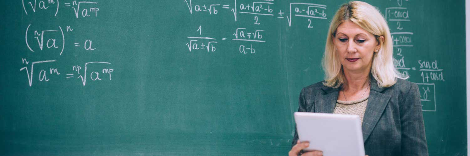 Female in front of black board using tablet