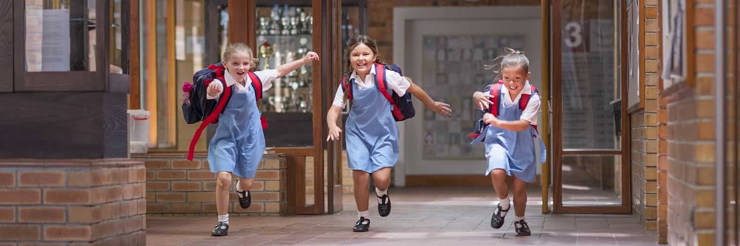 Young girls running out of school