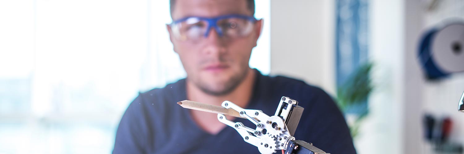 Student using robot arm in experiment