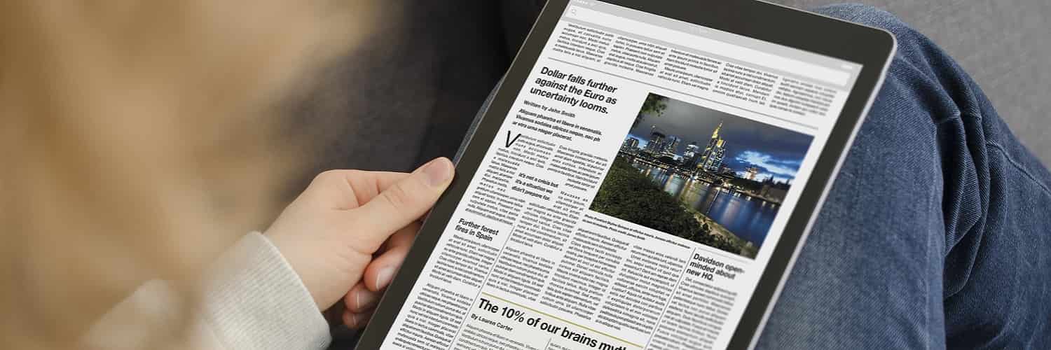 Woman reading English text from a newspaper on a tablet