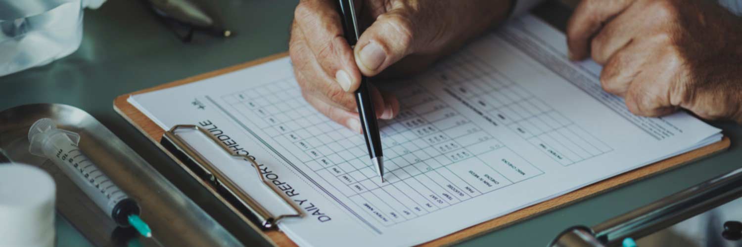 Person completing form on clipboard