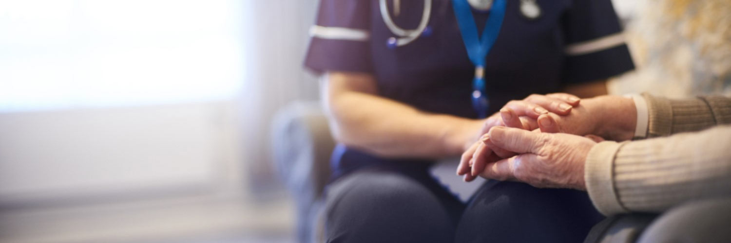 Nurse holding an older patient