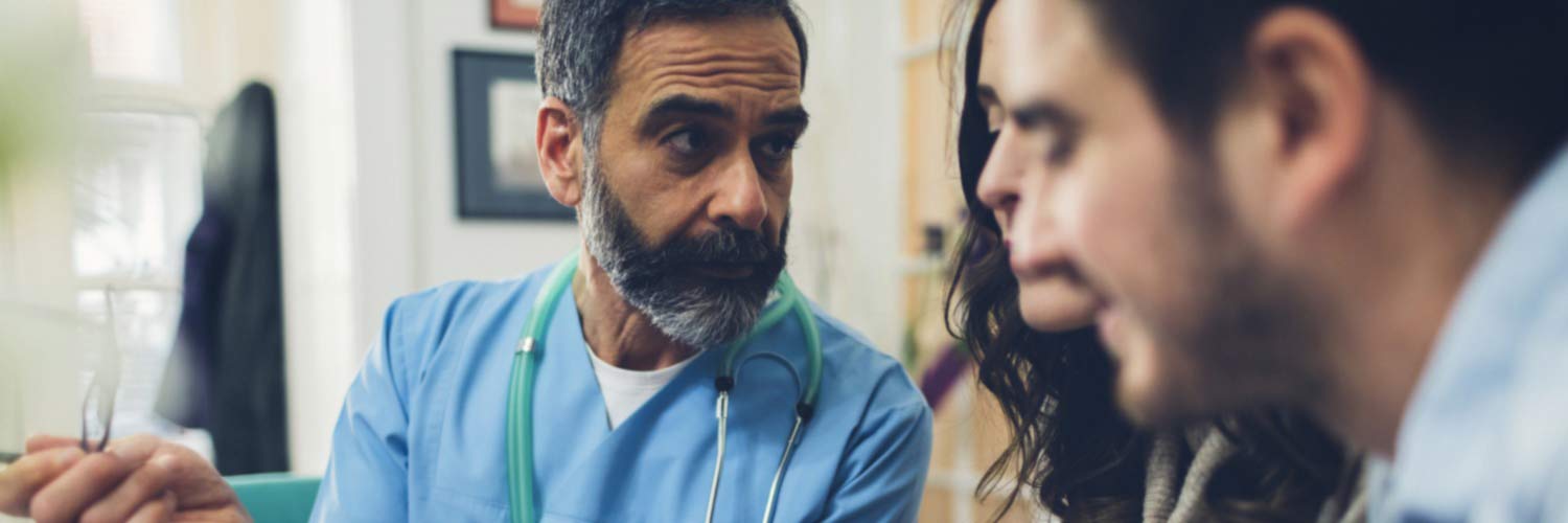 Doctor talking with two people