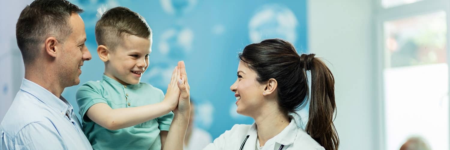 Nurse with a young boy and his father